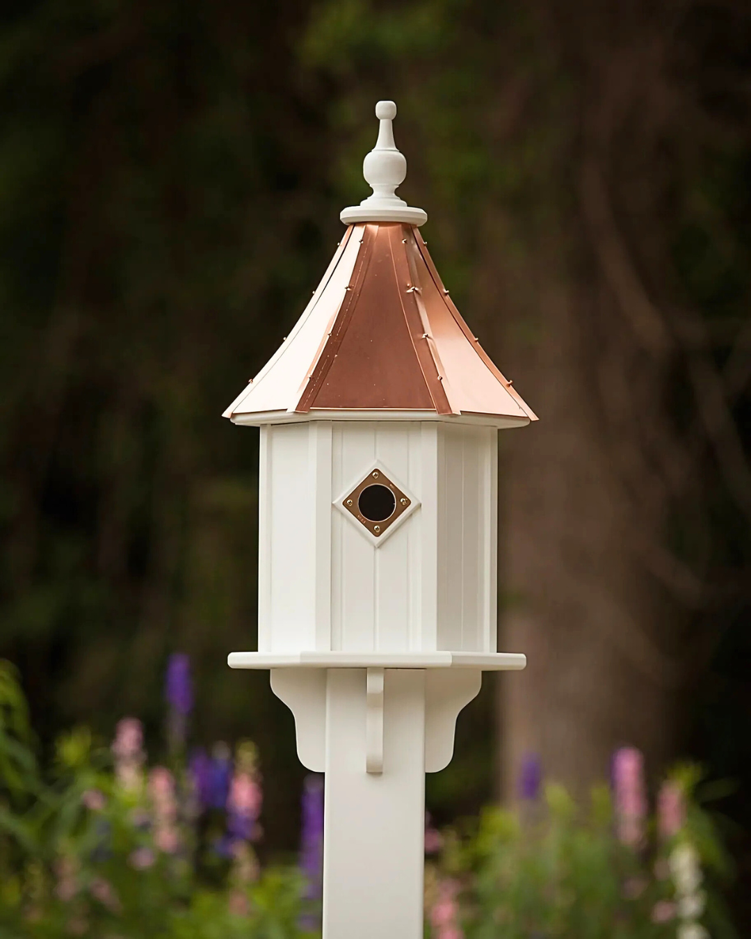 Traditional Copper Roof Birdhouse with PVC/Vinyl construction, 1.5" entry hole, and copper predator guard. Measures 28" tall x 10" wide, perfect for bluebirds and tree swallows. Maintenance-free, lift-off roof for easy cleaning. USA made with free shipping.