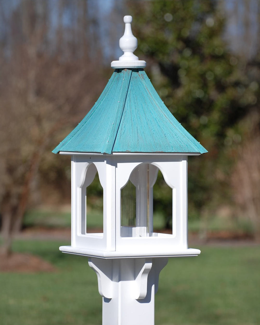 Handcrafted Unique Vinyl Bird Feeder with copper roof options, made from durable cellular expanded PVC. Features lift-off roof, heavy-duty acrylic tube (3" x 9"), and decorative brackets. Guaranteed maintenance-free with no rotting, cracking, or fading. USA-made, fits 4x4 post. Free shipping!