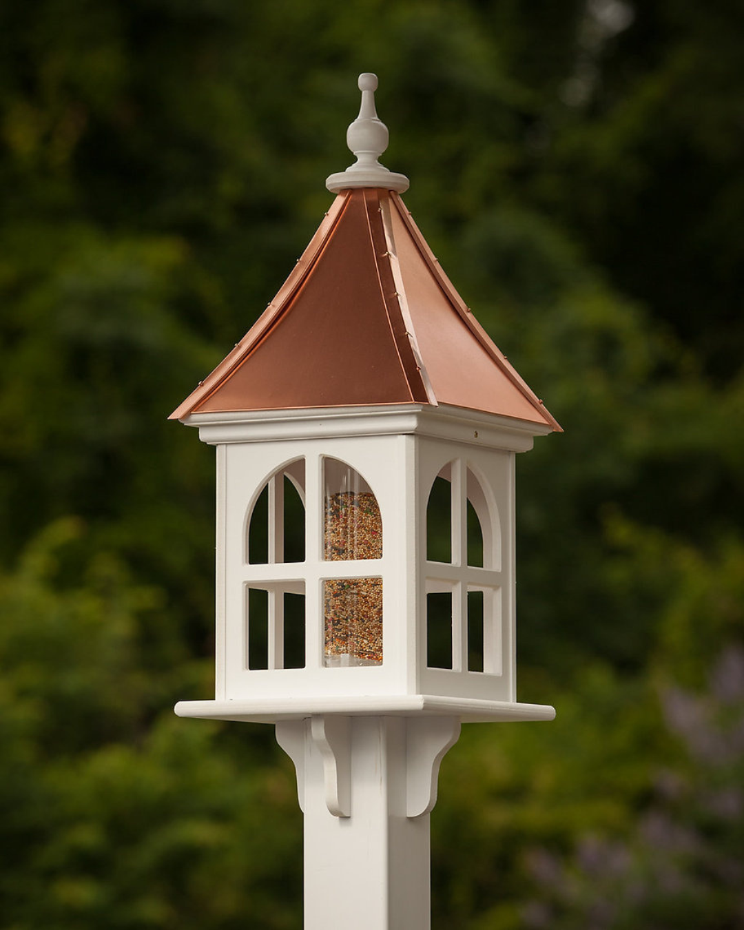 Handcrafted Copper Roof Bird Feeder with Arch Window, made from durable cellular PVC. Features a lift-off roof, 4x9 acrylic tube, and decorative brackets. Maintenance-free with no rotting, cracking, or fading. USA-made, fits 4x4 post. Bright or Patina Copper Roof options. Free shipping!