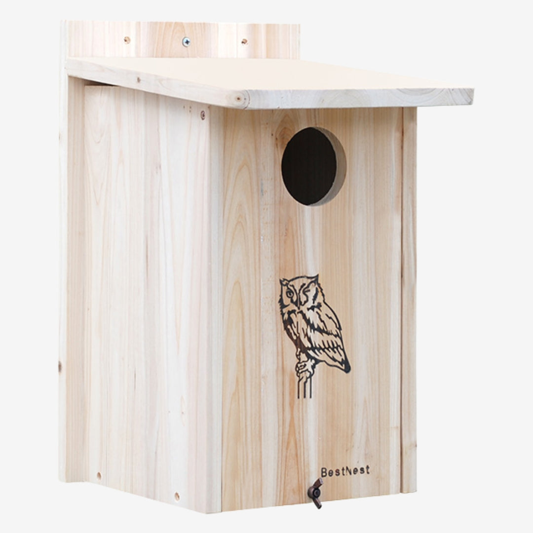 Close-up of BestNest cedar nesting house mounted on a tree, designed for screech owls and kestrels, with durable weather-resistant construction for wildlife shelter.